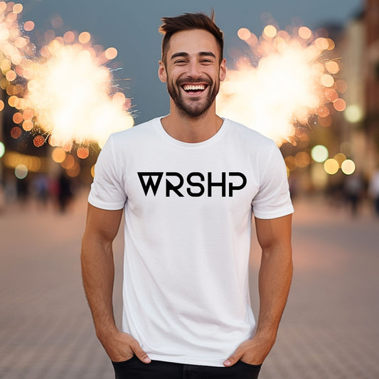 Man wearing a white t-shirt with 'WRSHP' logo in front of blurred fireworks